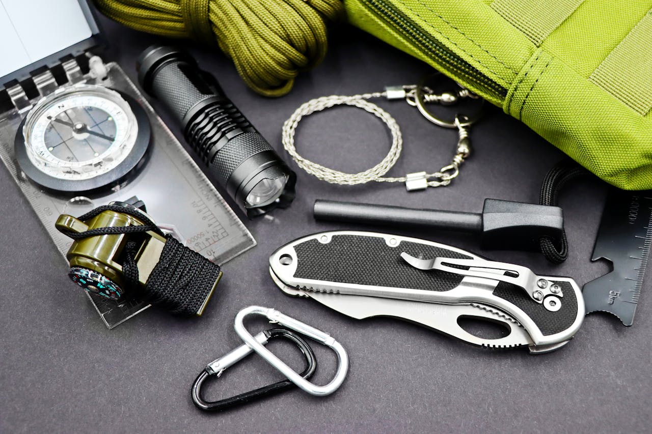 A comprehensive layout of essential survival tools including compass, flashlight, and knife, perfect for outdoor adventures.
